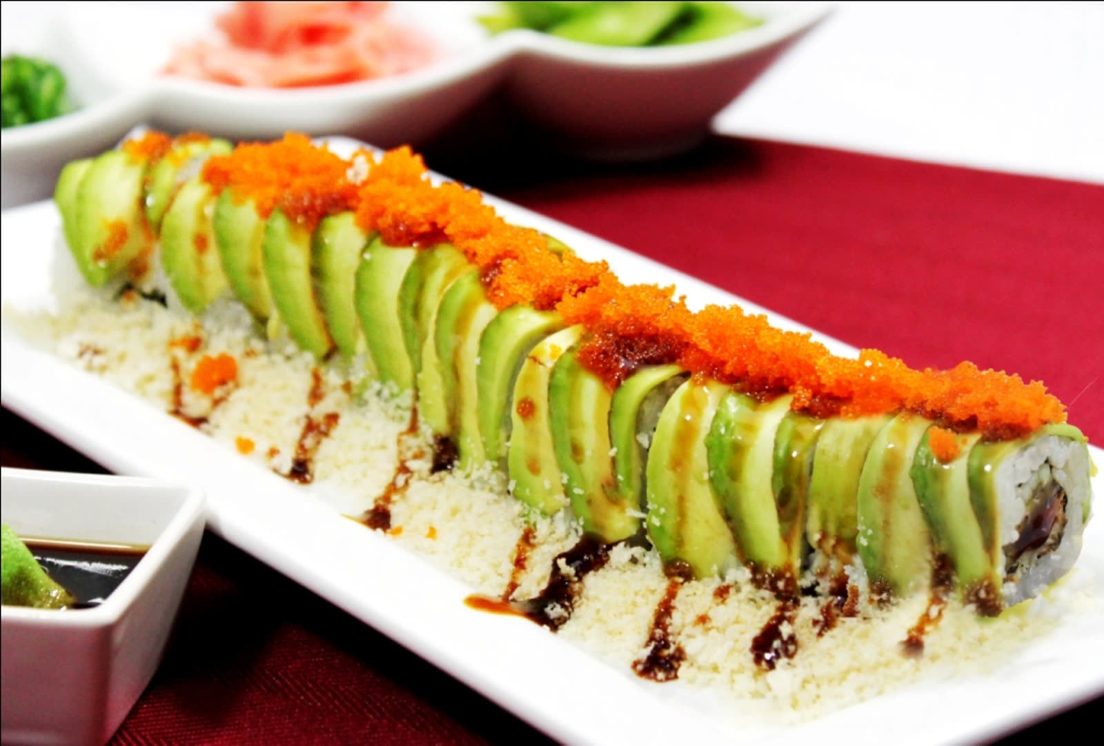 Fresh sushi roll topped with avocado